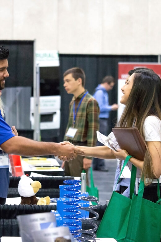 people shaking hands at a tradeshow
